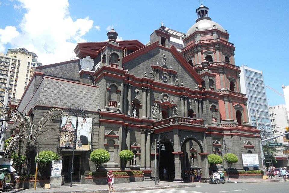 Historic Binondo Church in Manila, featuring its grey stone facade, red architectural details and bell tower