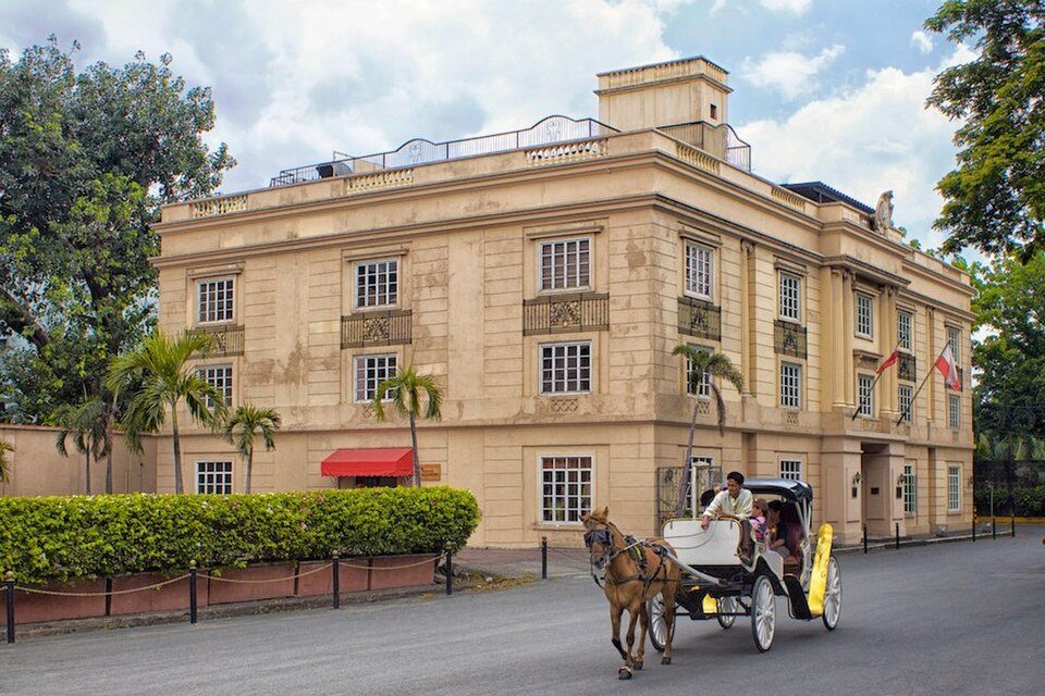 Horse-drawn kalesa parked near a historic building at Plaza de Armas in Intramuros, Manila