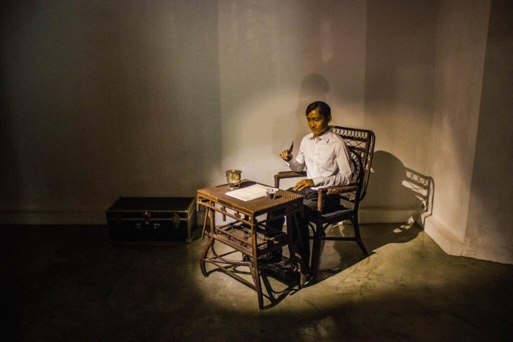 Museum display at Fort Santiago showing a seated figure of José Rizal writing at a desk