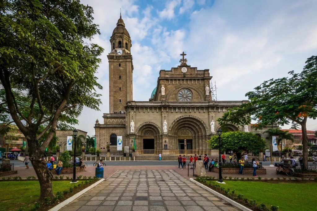 Manila Cathedral in Intramuros, showing its historic stone facade, bell tower and landscaped plaza