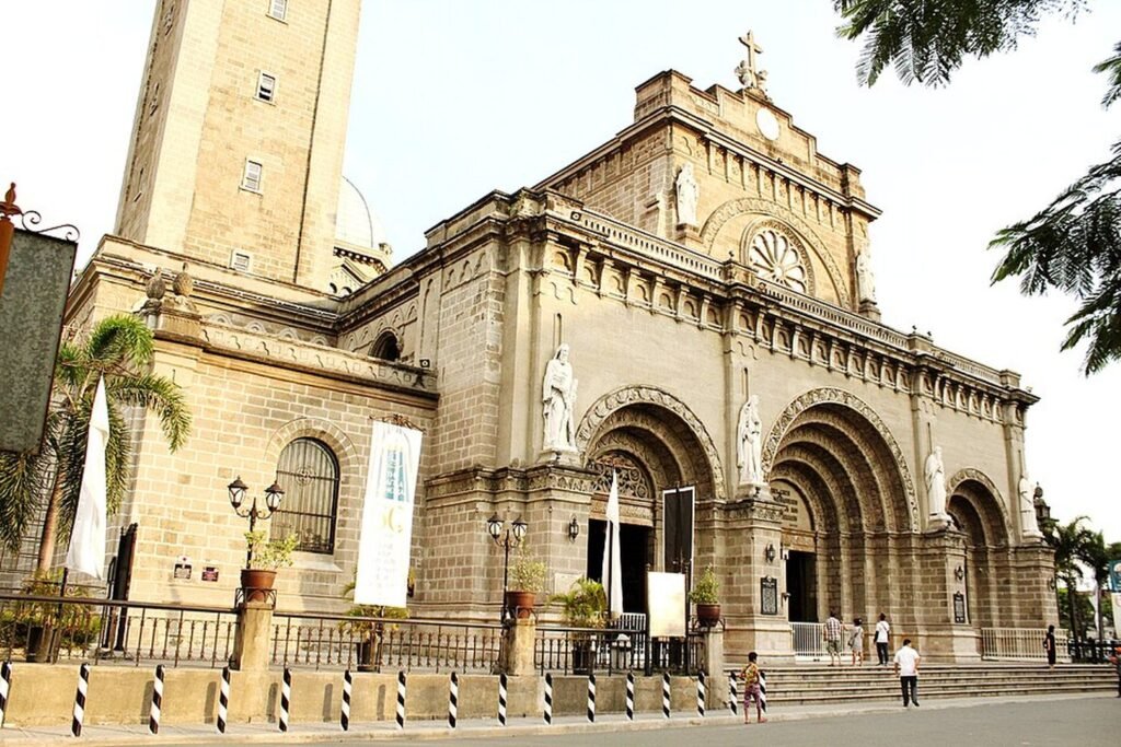Front facade of Manila Cathedral in Intramuros, showing its stone arches, statues and bell tower