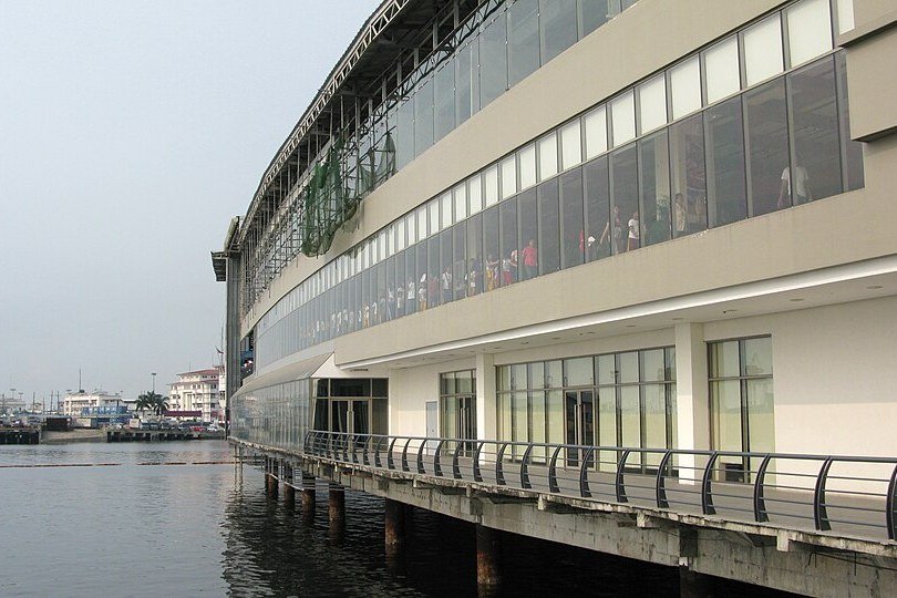 Exterior of Manila Ocean Park beside Manila Bay, showing the waterfront building and walkway