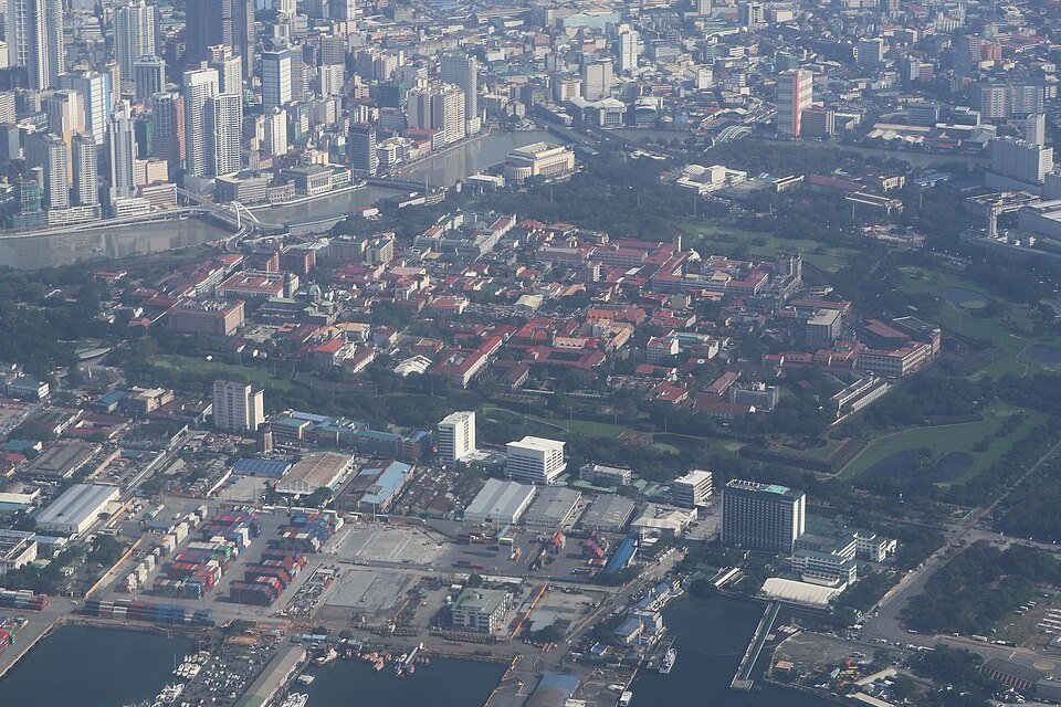 Aerial view of historic Intramuros in Manila, showing its old city walls, red-roofed buildings and surrounding urban areas