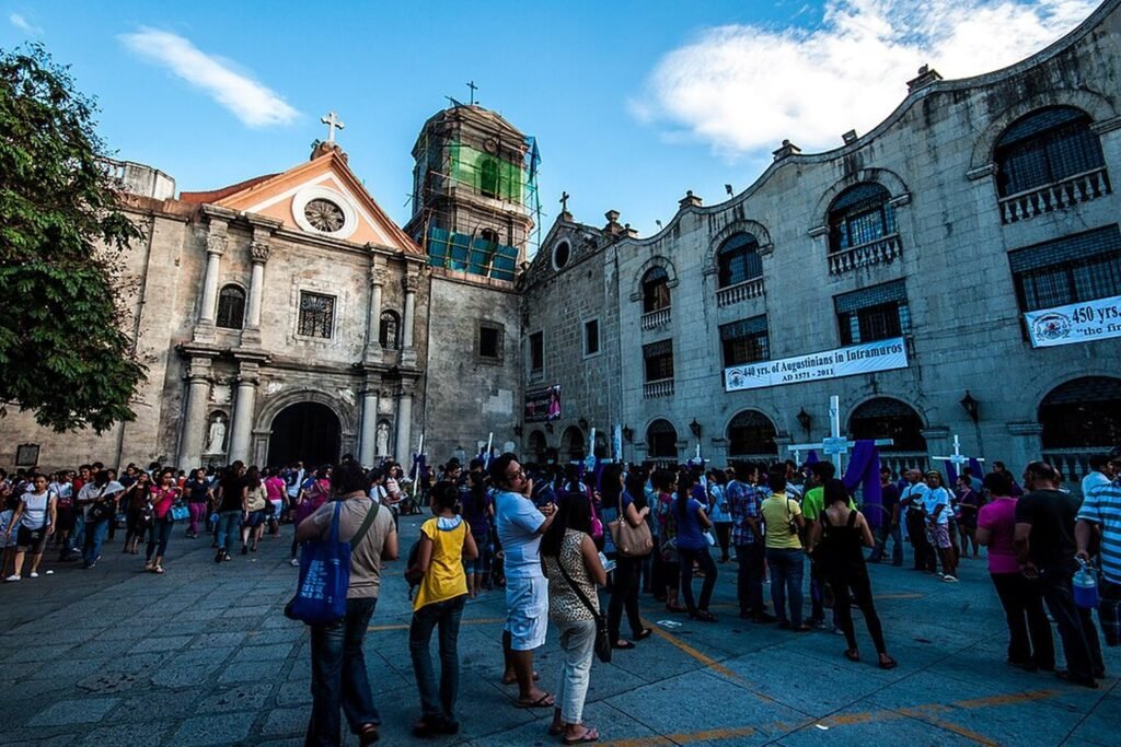 Crowds gathered outside San Agustin Church in Intramuros, Manila, beside its historic stone buildings