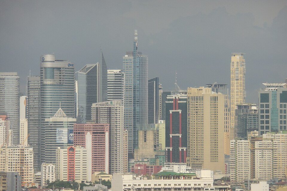 Makati skyline with densely packed office towers, hotels and residential high-rise buildings during the day